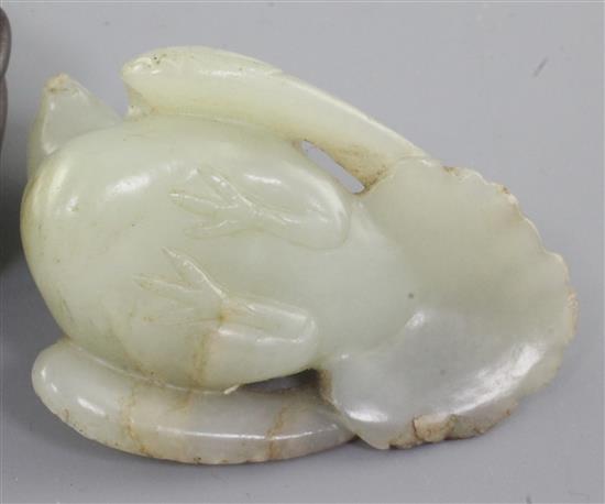 A Chinese celadon and russet jade figure of a recumbent bird, Ming dynasty, length 6.4cm, slight edge chips